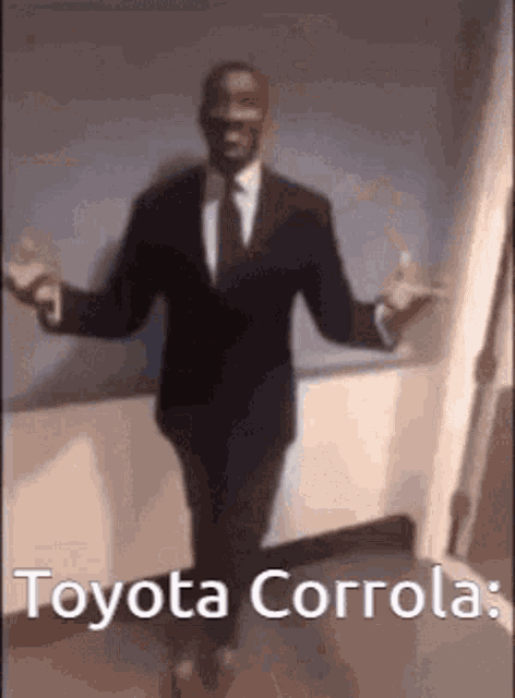 a man in a suit and tie is standing in a hallway with his arms outstretched and the words toyota corrola .
