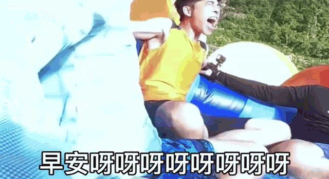 a man in a yellow shirt is sitting on a blue inflatable raft with chinese writing on it .