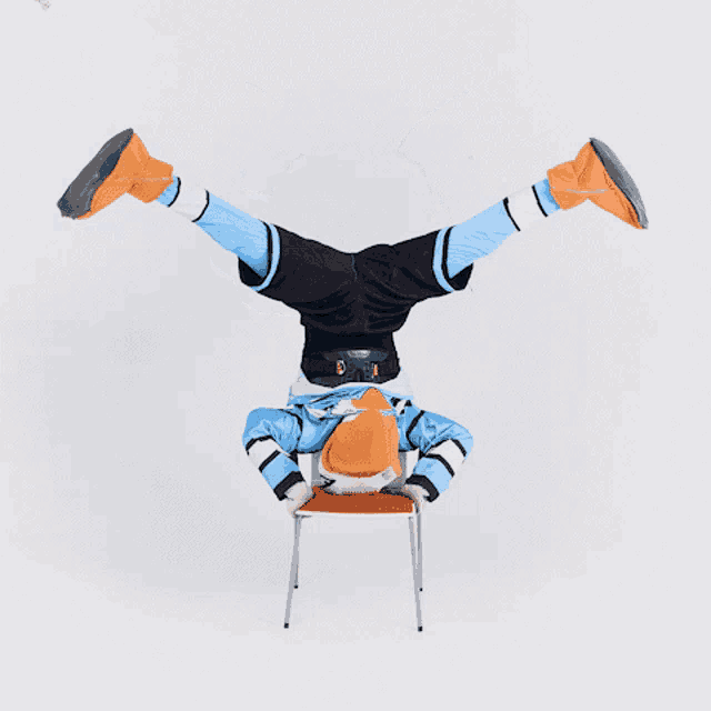 a person is doing a handstand on a chair