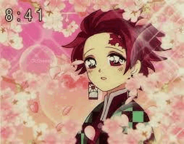 a young boy is standing in front of a pink background with flowers .