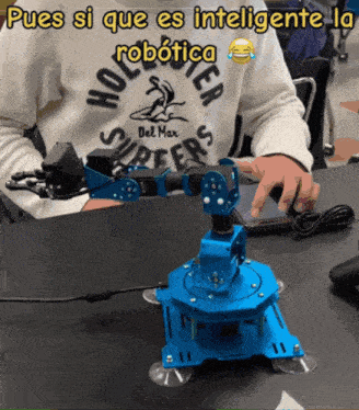 a person wearing a hollister sweatshirt is using a robotic arm
