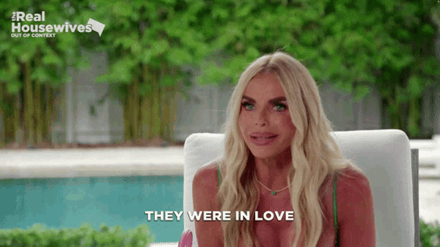 a woman is sitting in front of a pool with the words they were in love on the bottom