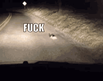 a blurred image of a road with the word fuck written on it