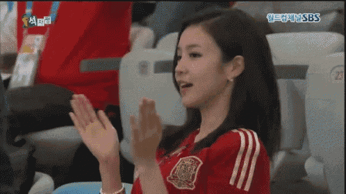 a woman in a red shirt with the word espana on it