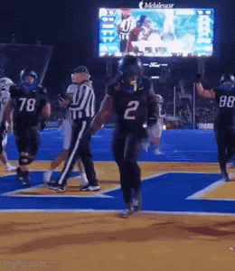 a football player wearing the number 2 jersey is running on the field