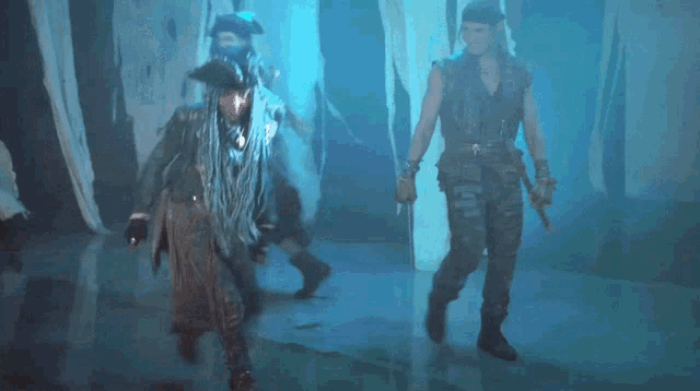 a group of people in pirate costumes are dancing