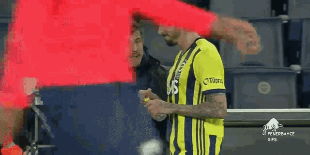 a man in a yellow and black striped jersey with the word tigers on the sleeve