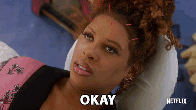 a woman laying on a bed with okay written on the bottom