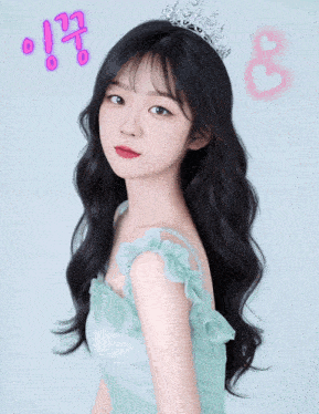 a girl wearing a green dress and a tiara with korean writing on the bottom