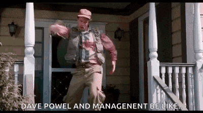 a man is standing on a porch in front of a house and dancing .