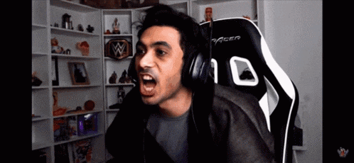 a man wearing headphones is sitting in a gaming chair