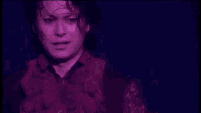 a close up of a person 's face in a dark room