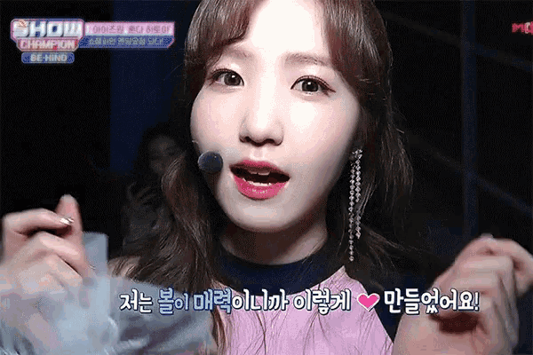 a girl with a microphone in her mouth says show champion