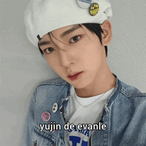 a young man wearing a white beret and a denim jacket has the name yujin de evanle on the bottom right