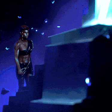 a statue of a man standing on a set of stairs in the dark