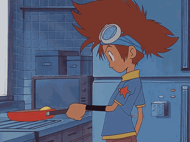 a boy in a blue shirt with a star on it is cooking