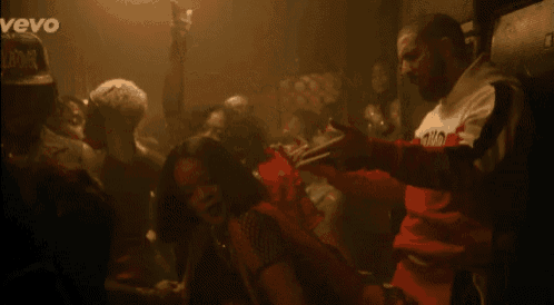 a group of people are dancing in a dark room with the word vevo on the bottom