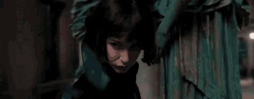 a close up of a woman 's face with a blue cloth behind her .