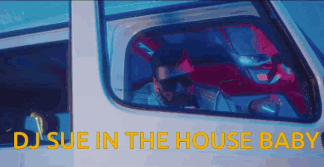 a man in sunglasses is driving a car with the words dj sue in the house baby written above him