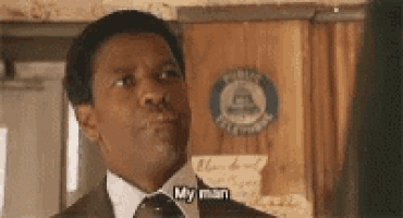 a man in a suit and tie is talking to another man .