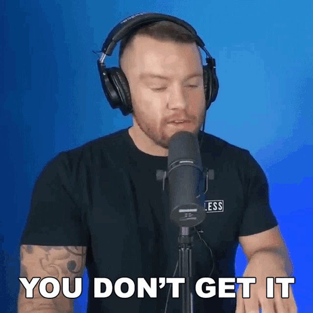 a man wearing headphones stands in front of a microphone and says " you don t get it "