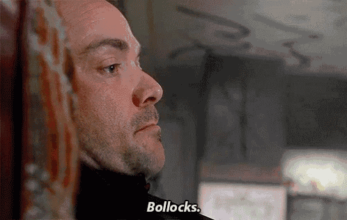 a close up of a man 's face with the words bollocks on the bottom