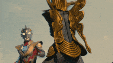 a close up of a statue with a man in a costume standing next to it