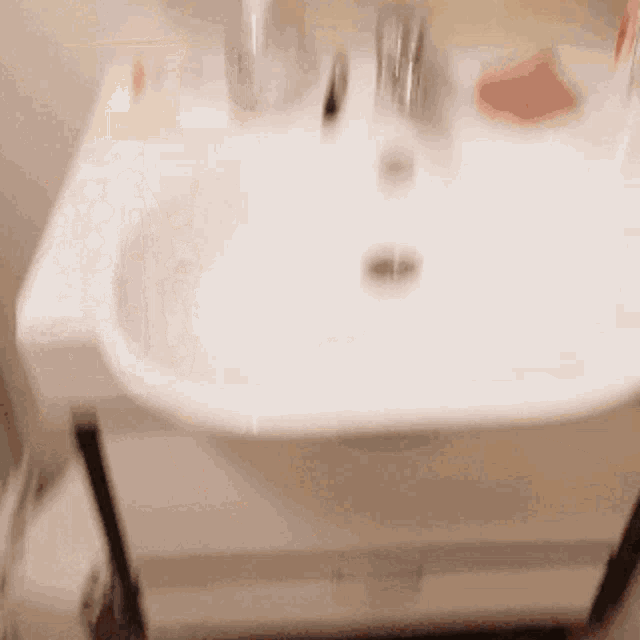 a bathroom sink with a soap dish and a toothbrush on it