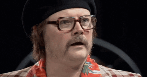 a man with glasses and a mustache is wearing a plaid shirt that says hawaii