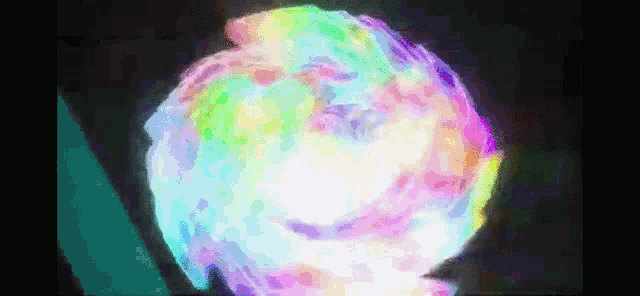 a computer generated image of a rainbow colored explosion