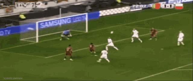 a soccer game is being played on a samsung lcd tv sponsored field