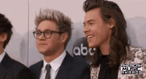 niall and harry are posing for a picture at the american music awards .