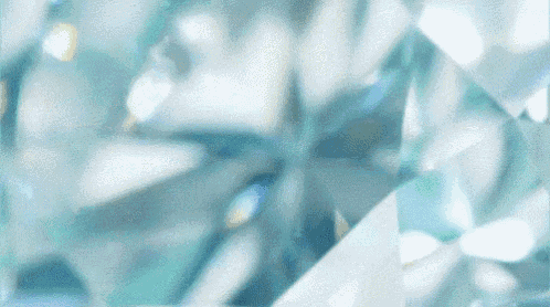 a close up of a blue and white diamond with a blurred background