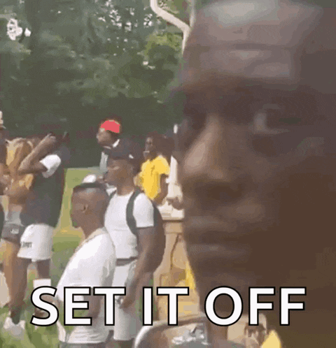 a man is standing in front of a group of people and says `` set it off ''