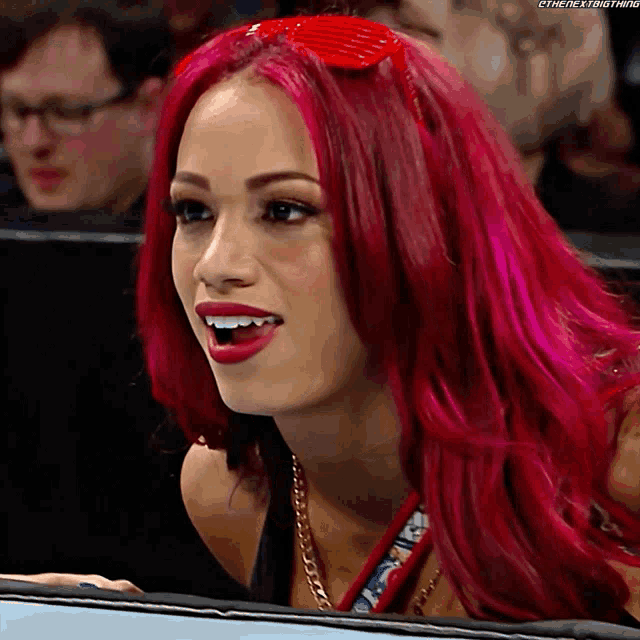 a woman with red hair has the hashtag #thenextbig thing on her face