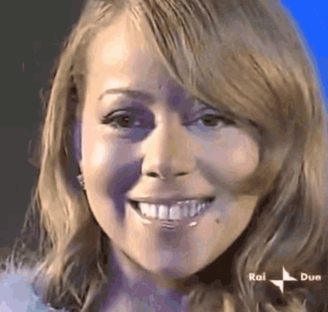 a close up of a woman 's face with rai due written on the bottom right