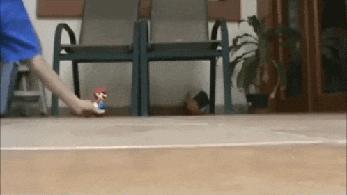 a person playing with a mario figure on a skateboard