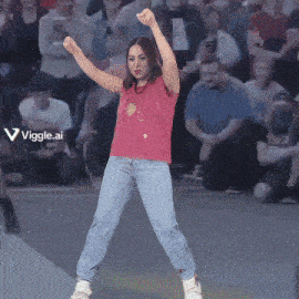 a woman in a red shirt and blue jeans is dancing in front of a crowd with a viggle.ai watermark in the corner