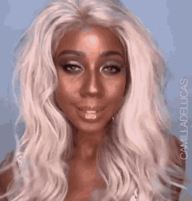 a close up of a woman 's face with a wig on