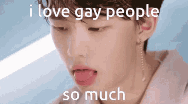 a close up of a person 's face with their tongue sticking out and the words `` i love gay people so much '' .