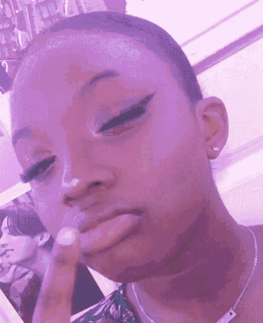 a woman is making a funny face while holding her finger to her mouth .