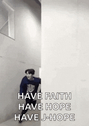 a man in a blue sweater is running between two walls and says `` have faith have hope have j-hope '' .