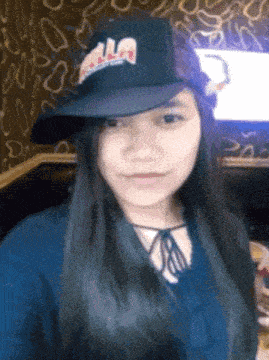 a woman wearing a black hat with the word aa on it