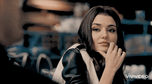 a woman with her hand on her chin looks at the camera with vivavideo written in the corner