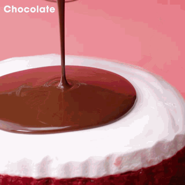 a red velvet cake with chocolate being poured on it