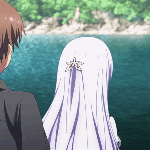 a girl with a flower in her hair is looking at a man