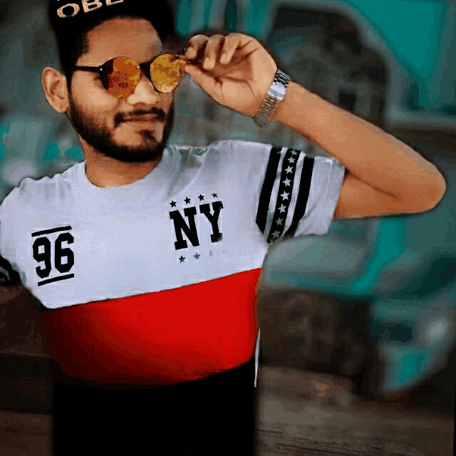 a man wearing sunglasses and a shirt with ny 96 on it