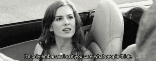 a woman is sitting in a car with a quote that says `` it 's only embarrassing if you care what people think ''