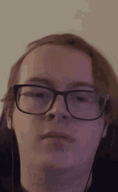 a close up of a person wearing glasses and earphones
