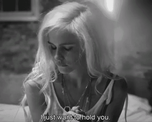 a black and white photo of a woman with the words i just want to hold you
